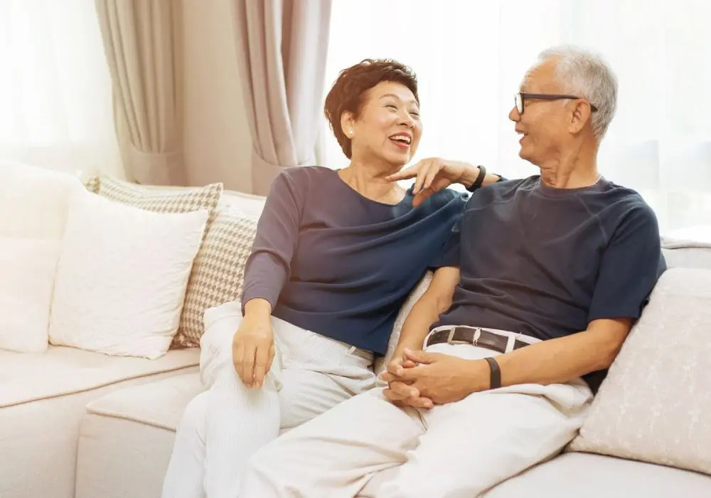 A man and woman sitting on the couch together.